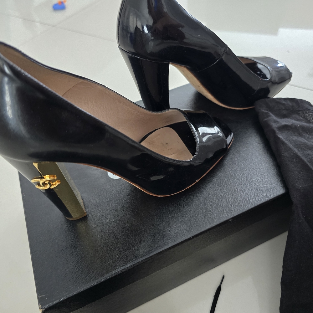 CHANEL Glossy Black Heels with Gold Accent